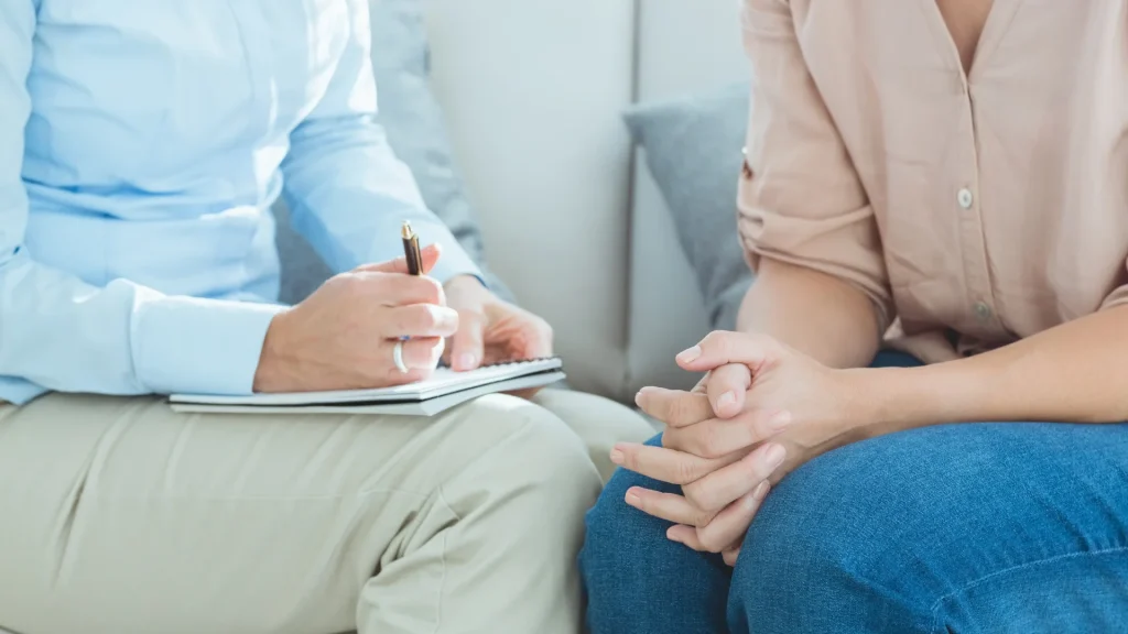 A therapist takes notes during a session.